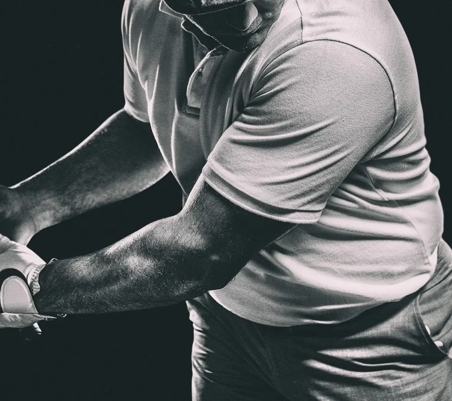 black and white photo of a man playing golf