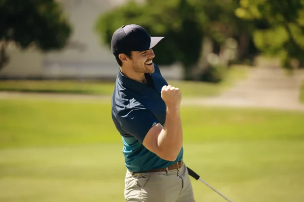 a man celebrates a great shot on the golf course