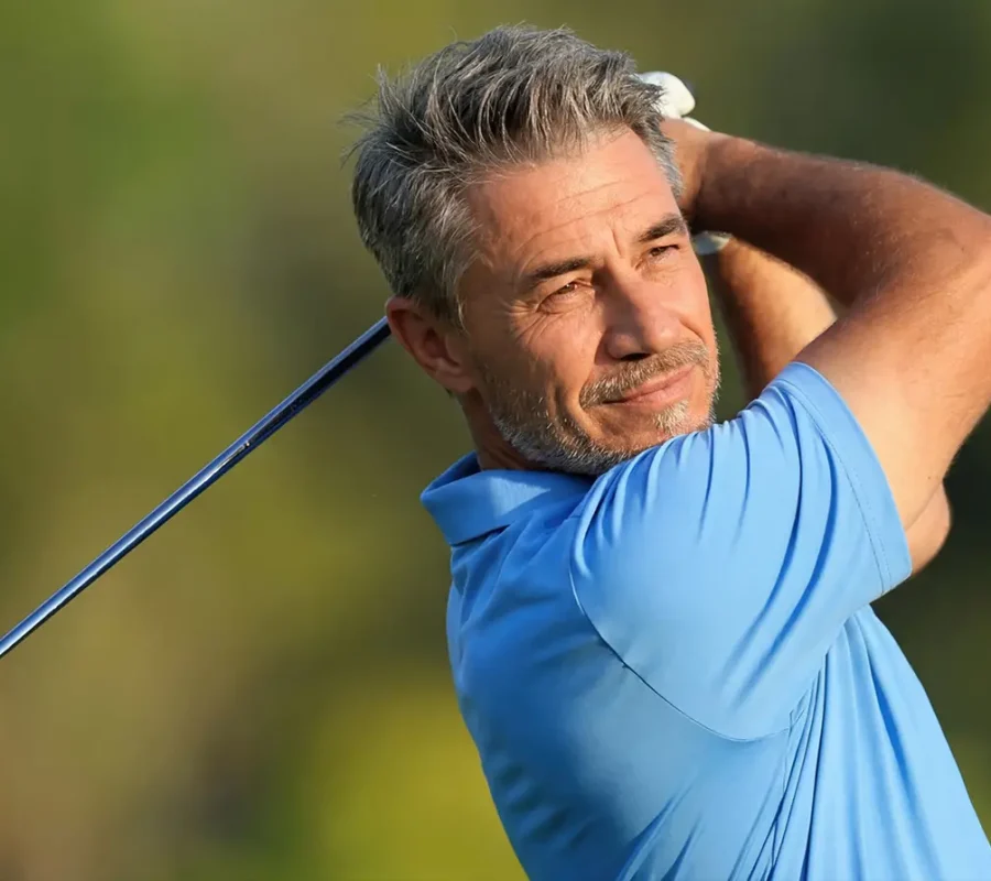 a middle ages man swings a golf club